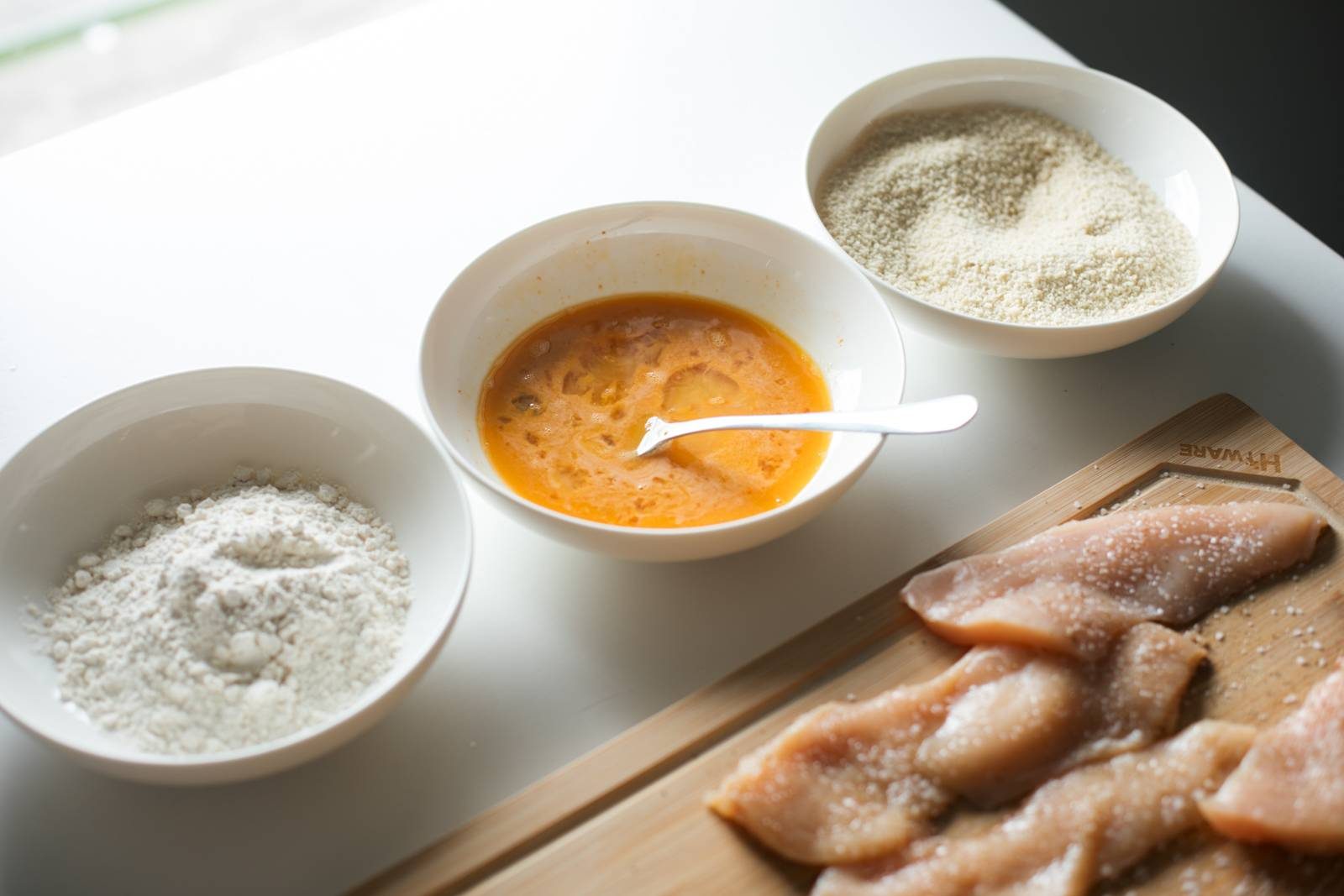 Flour, eggs, and panko in bowls.