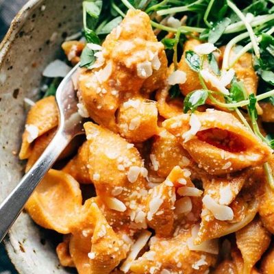 Creamy Tomato Shells in bowl with greens.
