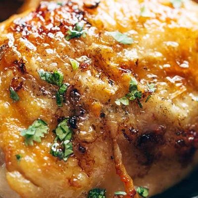 Honey Lemon Chicken in a cast iron pan.