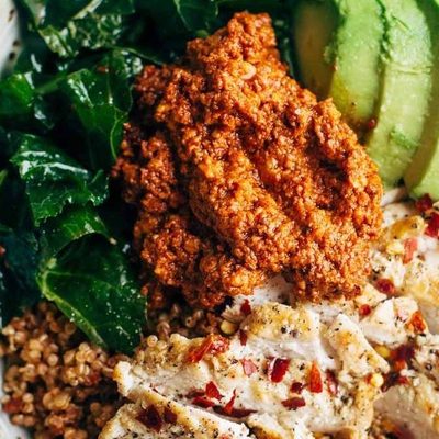 Kale and Chicken bowls with avocado and sauce.