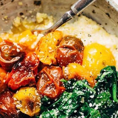 Roasted Tomatoes with Goat Cheese Polenta in a bowl with a fork.