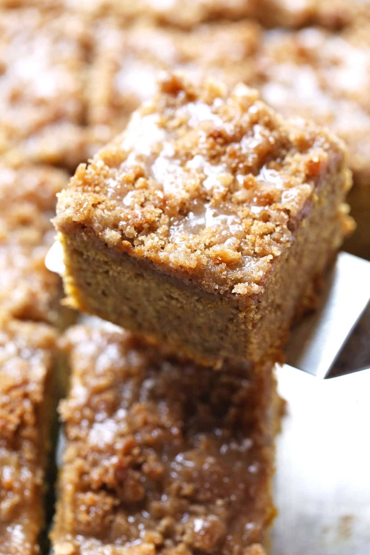 Cinnamon Streusel Pumpkin Coffee Cake with Maple Glaze on a piece.